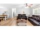 Bright living room with hardwood floors, neutral walls, and comfortable leather sofas at 37 Winesap Ct, Temple, GA 30179