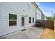View of the home's backyard with a concrete patio, lawn and fencing at 5584 Cannonade Ln, Stonecrest, GA 30058