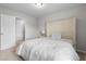 Bedroom featuring a queen bed with an upholstered headboard and carpet flooring at 5584 Cannonade Ln, Stonecrest, GA 30058