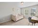 Bedroom with carpet flooring, daybed with pink pillows and a writing desk with chair at 5584 Cannonade Ln, Stonecrest, GA 30058