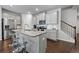 Modern kitchen with granite counters, stainless appliances, island with seating, and ample cabinet space at 5584 Cannonade Ln, Stonecrest, GA 30058