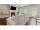 Cozy living room with a fireplace, ceiling fan, hardwood floors, and ample natural light at 5584 Cannonade Ln, Stonecrest, GA 30058