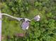 Aerial view of a secluded property with a house, large lawn, and surrounding trees at 6125 Fouts Mill Rd, Douglasville, GA 30135