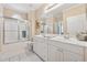 Bright bathroom features a double vanity, framed mirror, and shower with glass door at 6125 Fouts Mill Rd, Douglasville, GA 30135