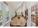 Bright dining room with vaulted ceilings, multiple windows, and access to a covered patio at 6125 Fouts Mill Rd, Douglasville, GA 30135