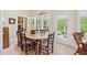 Elegant dining area with wooden table, chairs, and glass doors leading to a bright backyard at 6125 Fouts Mill Rd, Douglasville, GA 30135