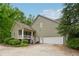 Well-maintained exterior with attached garage and charming front porch at 6125 Fouts Mill Rd, Douglasville, GA 30135