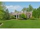 Inviting home with stone accents, a well-kept lawn, and mature landscaping at 6125 Fouts Mill Rd, Douglasville, GA 30135