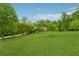 Sprawling front lawn leading up to a home surrounded by lush trees at 6125 Fouts Mill Rd, Douglasville, GA 30135