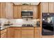 Well-appointed kitchen featuring custom cabinets, modern appliances, and stone countertops at 6125 Fouts Mill Rd, Douglasville, GA 30135