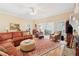 Warm living room with hardwood floors, stone fireplace and access to a dining area at 6125 Fouts Mill Rd, Douglasville, GA 30135