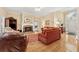 Bright living room features hardwood floors, a stone fireplace, and elegant furnishings at 6125 Fouts Mill Rd, Douglasville, GA 30135