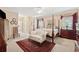 Comfortable main bedroom boasts a four-poster bed, sitting area, and neutral tones at 6125 Fouts Mill Rd, Douglasville, GA 30135