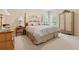 Spacious bedroom with a four-poster bed, patterned linens, and natural light from large windows at 6125 Fouts Mill Rd, Douglasville, GA 30135