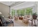 Inviting sunroom with lots of natural light, multiple chairs and views of the backyard at 6125 Fouts Mill Rd, Douglasville, GA 30135