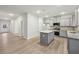 Open kitchen concept features granite countertops, stainless appliances, and hardwood floors throughout at 1462 Stephens View Dr, Loganville, GA 30052