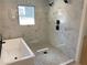 Bathroom features a luxurious shower and a modern tub, complete with marble-style tiles at 2167 Main Nw St, Atlanta, GA 30318