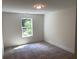Cozy bedroom with carpet flooring and a window offering a view of the outdoors at 2167 Main Nw St, Atlanta, GA 30318