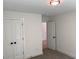 Bright bedroom features neutral walls, carpeted floors, a closet, and an open door at 2167 Main Nw St, Atlanta, GA 30318