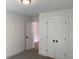 Bright bedroom features neutral walls, carpeted floors, a closet, and an open door at 2167 Main Nw St, Atlanta, GA 30318