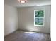 Cozy bedroom with carpet flooring and a window offering a view of the outdoors at 2167 Main Nw St, Atlanta, GA 30318