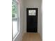 Clean entryway featuring light wood floors, white walls, and a black front door with window at 2167 Main Nw St, Atlanta, GA 30318