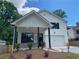 Charming two-story home featuring white siding, a covered front porch, and a paved driveway at 2167 Main Nw St, Atlanta, GA 30318