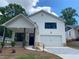 Charming two-story home featuring white siding, a covered front porch, and a paved driveway at 2167 Main Nw St, Atlanta, GA 30318