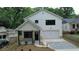 Charming two-story home featuring white siding, a covered front porch, and a paved driveway at 2167 Main Nw St, Atlanta, GA 30318