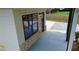 Inviting front porch features dark wood columns, brick accents, and a stylish front door at 2167 Main Nw St, Atlanta, GA 30318