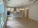 Open floor plan kitchen with stainless appliances, granite countertops, and hardwood flooring at 2167 Main Nw St, Atlanta, GA 30318