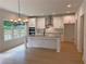 Bright, open kitchen with large island, stainless steel appliances, and modern lighting fixture at 2167 Main Nw St, Atlanta, GA 30318