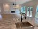 Open-concept kitchen island features stainless steel sink, marble countertops, and designer lighting at 2167 Main Nw St, Atlanta, GA 30318