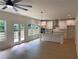 Bright, open kitchen with white cabinets, stainless hood, modern lighting and island with light countertops at 2167 Main Nw St, Atlanta, GA 30318