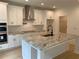 Bright kitchen boasts white cabinetry, stainless appliances, and a spacious marble-topped island at 2167 Main Nw St, Atlanta, GA 30318