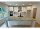 Well-equipped kitchen featuring white cabinetry, stainless appliances, and spacious island with granite countertops at 2167 Main Nw St, Atlanta, GA 30318