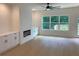 Bright open-concept living room with wood floors, built-in cabinets, a fireplace, and large windows providing natural light at 2167 Main Nw St, Atlanta, GA 30318