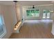 Bright open-concept living room with fireplace, built-in cabinets, and modern lighting fixtures, featuring backyard views at 2167 Main Nw St, Atlanta, GA 30318