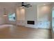 Open-concept living room featuring a modern fireplace, custom cabinets, wood floors, and modern lighting at 2167 Main Nw St, Atlanta, GA 30318