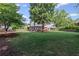 Expansive backyard with lush lawn, mature trees, a cozy hammock, and a patio ideal for outdoor gatherings at 6355 Stallion Dr, Cumming, GA 30040