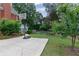 Spacious backyard with a basketball hoop, lush lawn, and mature trees, creating a private and recreational space at 6355 Stallion Dr, Cumming, GA 30040