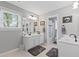A bright bathroom featuring dual sinks, a large mirror, and a shower-tub combo in a clean, neutral palette at 6355 Stallion Dr, Cumming, GA 30040