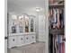 A well-organized closet and dressing area with a large display cabinet and ample storage space, all painted white at 6355 Stallion Dr, Cumming, GA 30040