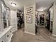 A massive walk-in closet features carpeting, an armoire, shelving, and custom storage solutions at 6355 Stallion Dr, Cumming, GA 30040
