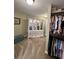 A spacious closet area features an armoire, lots of space for storage, shelving, and many hanging clothes at 6355 Stallion Dr, Cumming, GA 30040