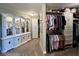 Spacious walk-in closet with custom built-ins, shelving, and ample storage for clothes and accessories at 6355 Stallion Dr, Cumming, GA 30040