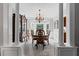 Traditional dining room with large bay window, ornate chandelier, and wood table with seating for six at 6355 Stallion Dr, Cumming, GA 30040