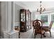 Elegant dining room featuring dark wood china cabinet, chandelier, and bay window at 6355 Stallion Dr, Cumming, GA 30040