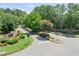 Stone entrance to Polo Golf and Country Club, featuring manicured landscaping and mature trees at 6355 Stallion Dr, Cumming, GA 30040