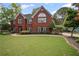 Well-kept brick home with a pristine lawn and tasteful landscaping at 6355 Stallion Dr, Cumming, GA 30040